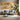 Elegant Cranes Flying Over Abstract Golden Canvas with Textured Patterns